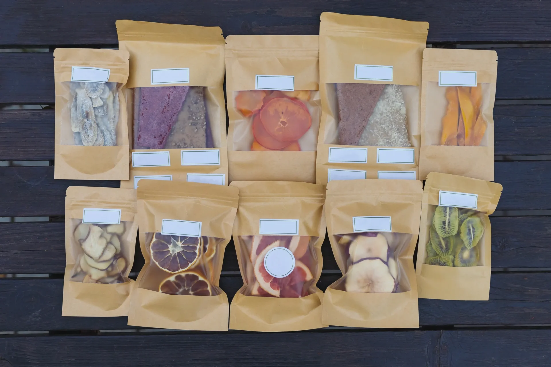 A bunch of different types of dried fruit in bags.